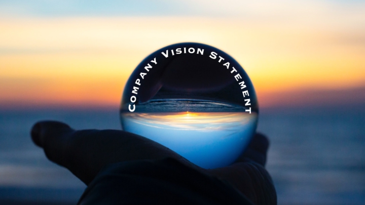 Hand with Crystal Ball with Words - Company Vision Statement Examples