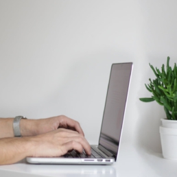 Man on laptop setting up LinkedPhone's cloud-based phone system