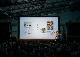 Sales pitch with app screen in front of crowd